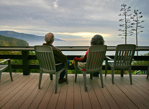 Adirondack chairs on a wooden deck at Lucia Lodge overlooking the coastline