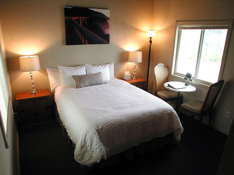 Vaulted wood-beam ceiling and ocean-view sitting area in the Lucia Lodge honeymoon cottage