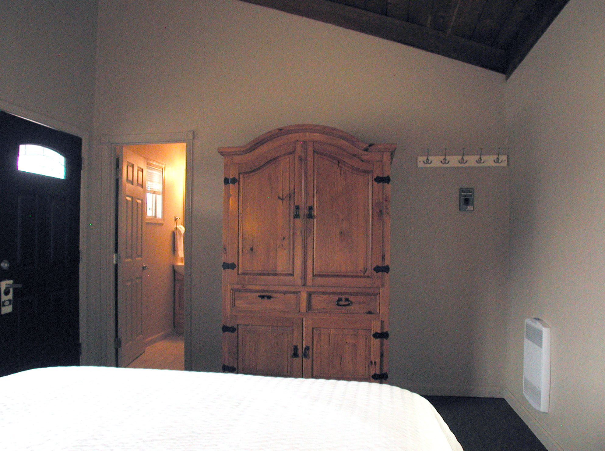 Vaulted wood-beam ceiling and ocean-view sitting area in the Lucia Lodge honeymoon cottage