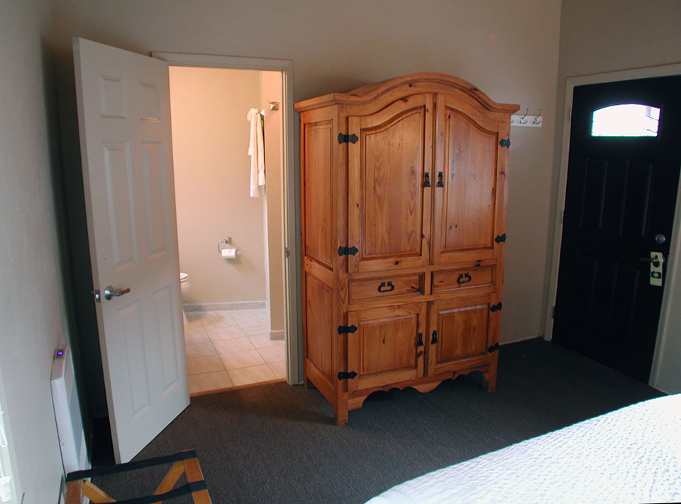Mountain view room at Lucia Lodge with exposed wood beam ceiling and sofa bed