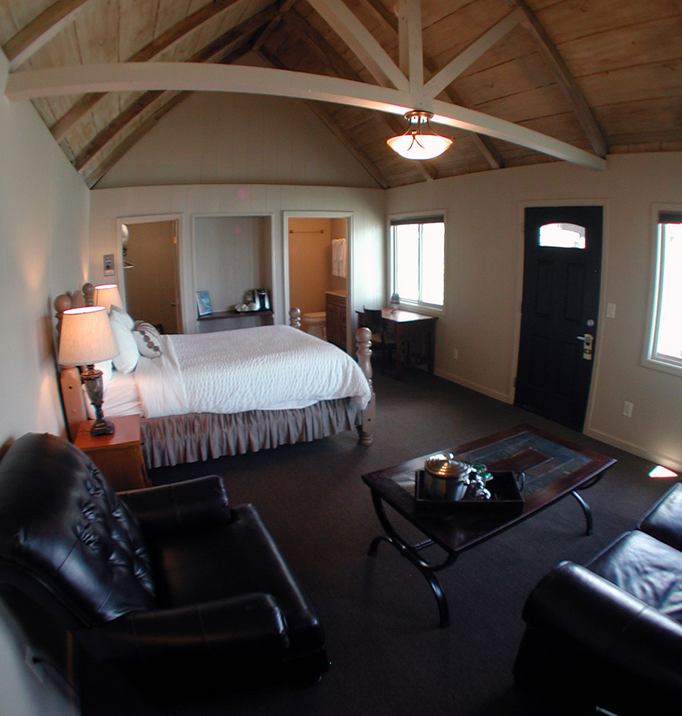 Mountain view room with exposed wood beam ceiling at Lucia Lodge